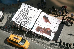 �^�C���Y�E�X�N�G�A�ł̃��b�Z�[�W�uHealth Workers Save Lives�v